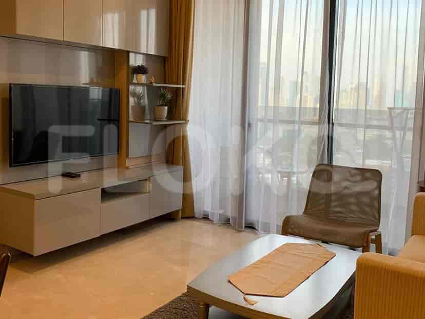 Living room with a seating area and balcony access.