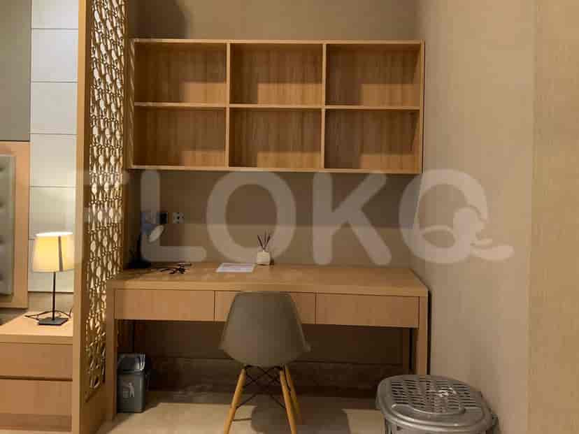 Study area with a desk, shelves, and chair.