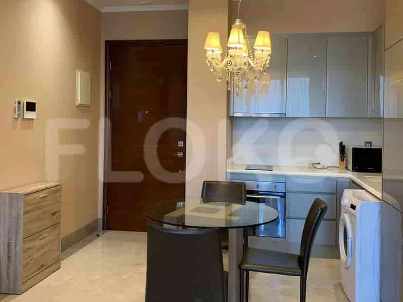 Kitchen and dining area with a round table and chandelier.