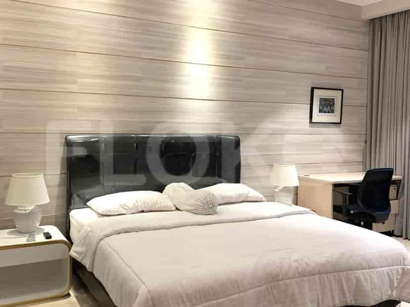 Bedroom with a bed, bedside tables, and desk.