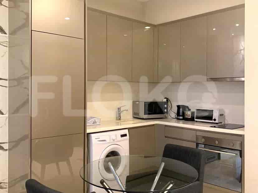 A modern kitchen with essential appliances and a dining area.