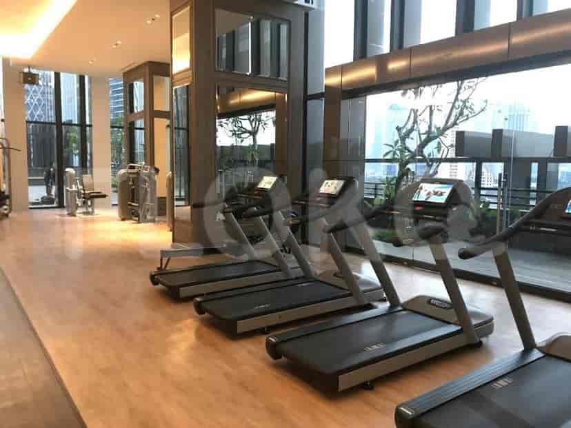 A gym with treadmills and a view of the city.