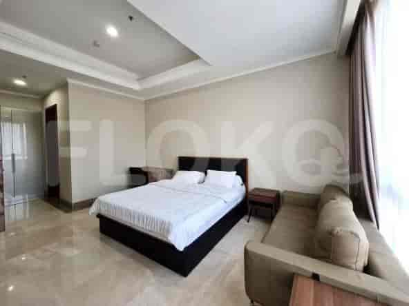 A bedroom featuring a bed, sofa, and a large window.