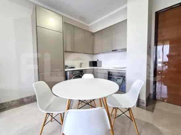 A kitchen area with a dining table and chairs.