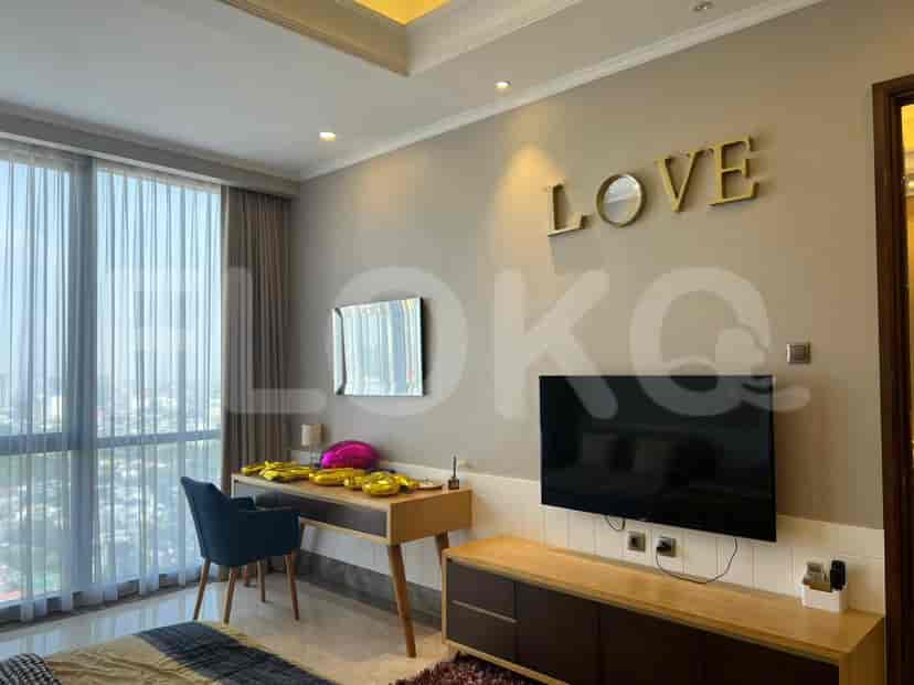 A bedroom with a desk, large window, and a 'LOVE' wall decoration.