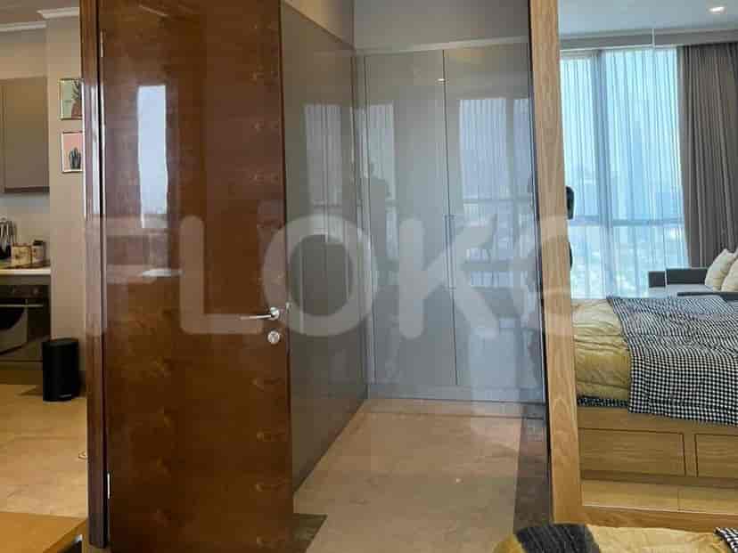 Bedroom with a large mirror and closet.