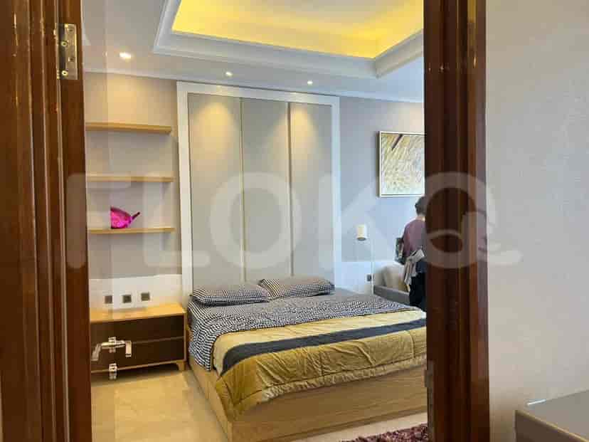 Bedroom with bed, shelves, and a doorframe view.