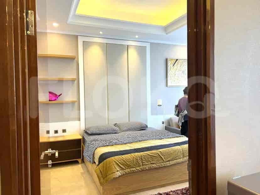 Bedroom with a bed, shelving and a doorway.
