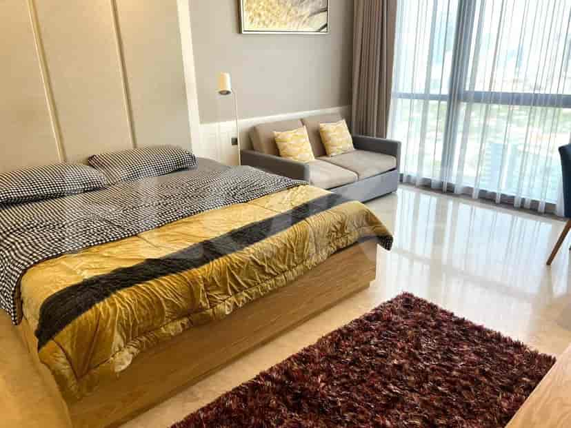 Bedroom with a bed and a sofa, showcasing a blend of textures and styles.