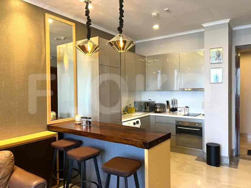 A modern kitchen featuring a breakfast bar, stainless steel appliances, and a mix of open and closed storage.