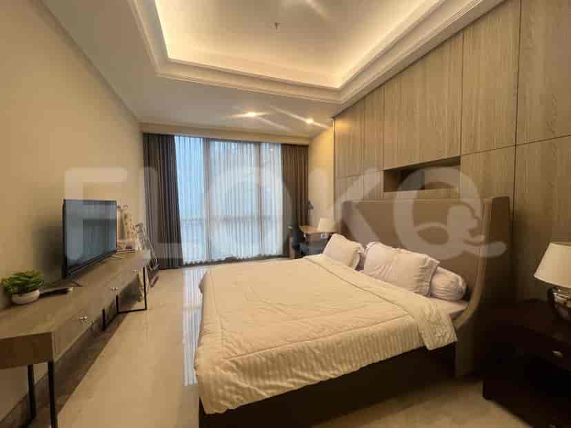 Bedroom with a king-sized bed and a large window.