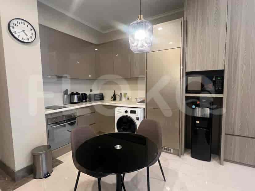 Modern kitchen with a washer and dining area.