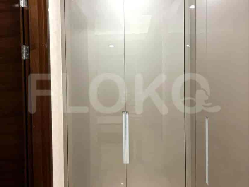 A view of a closet, showcasing the glass doors.
