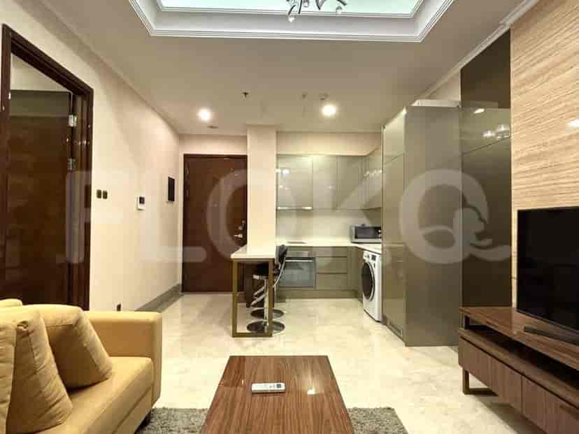 A combined living room and kitchen area, featuring modern cabinetry and appliances.