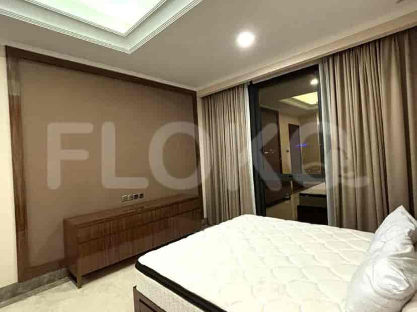 Bedroom with bed, nightstand, window, and large cabinet.
