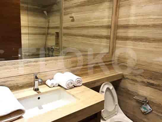 A modern bathroom with a sink and a large mirror.