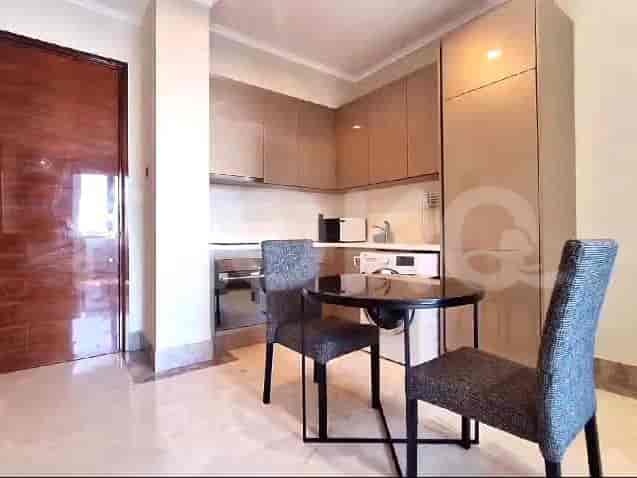 A compact kitchen with modern appliances and a dining area.