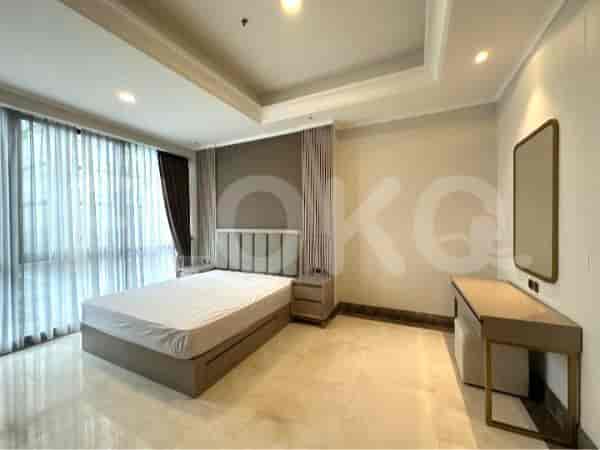 Bedroom with a bed, vanity, and large windows.