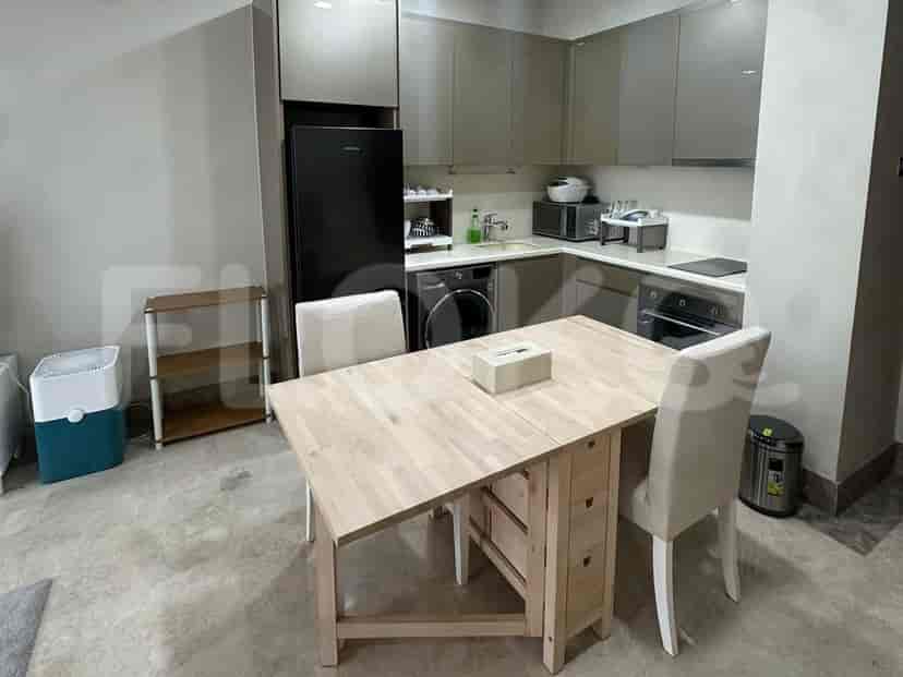 Functional kitchen with modern appliances, a wooden dining table, and a view of a well-equipped cooking area.