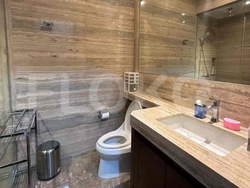 Stylish bathroom with a marble-like design and a spacious mirror.