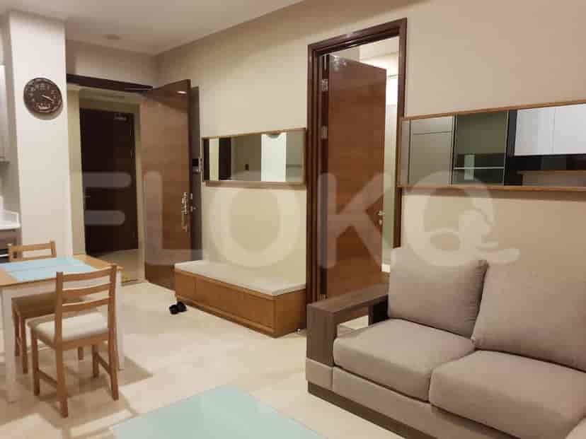 Hallway featuring wooden doors, a bench, and mirrors.