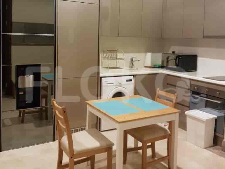 Compact kitchen with a dining area, appliances, and minimalist design.