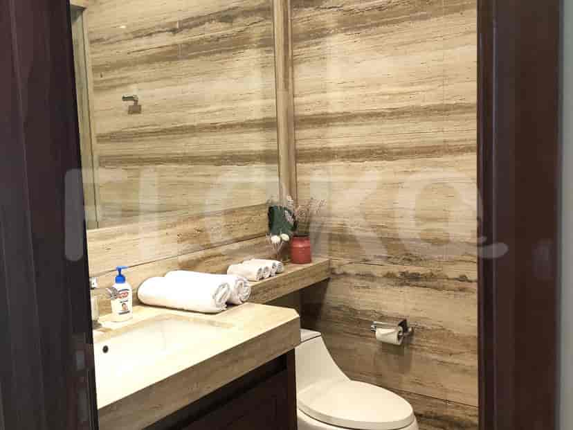 Another view of the bathroom, showcasing the marble details and toilet.