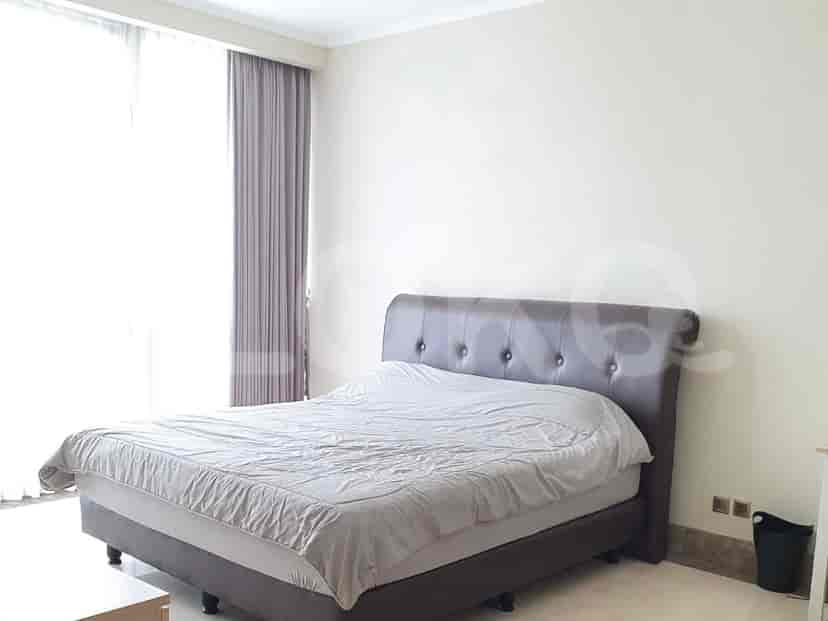 A bedroom with a large bed and curtains.
