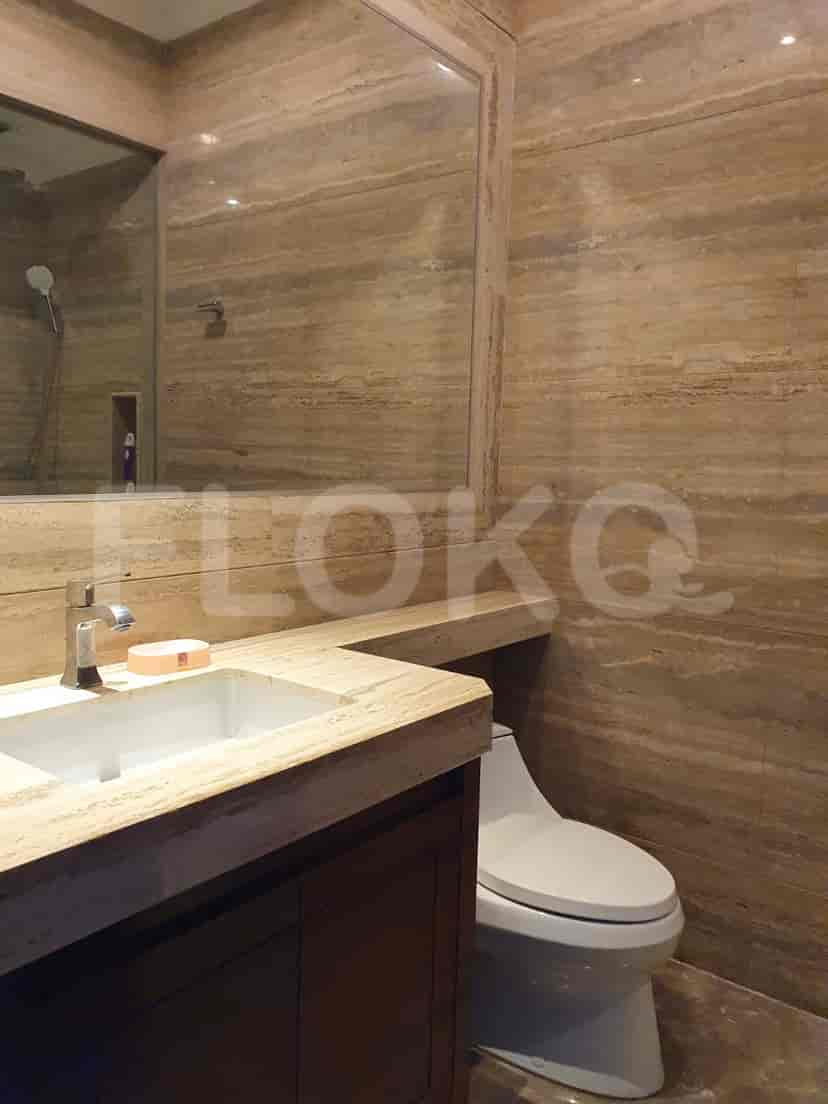 A bathroom featuring stone walls and a faucet.