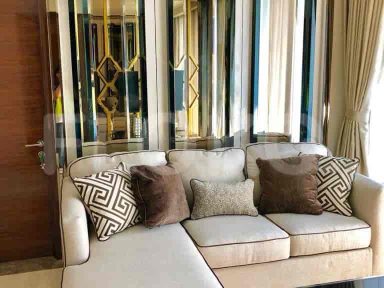 Another view of the living room, highlighting the sofa and the decorative mirrors.