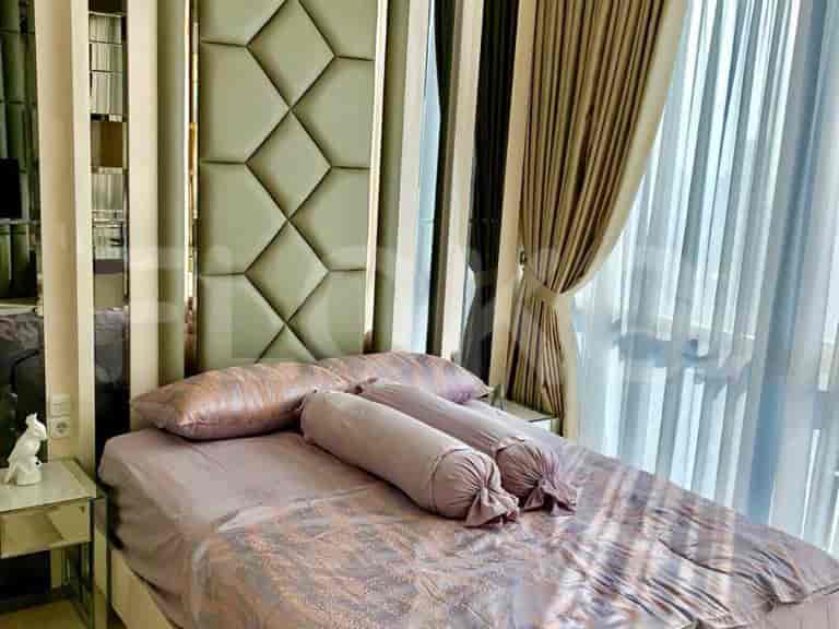 A modern bedroom with a double bed, decorative mirrors, and large windows.