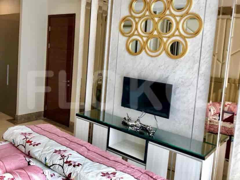 Another view of the bedroom, featuring a smart TV and a modern design.