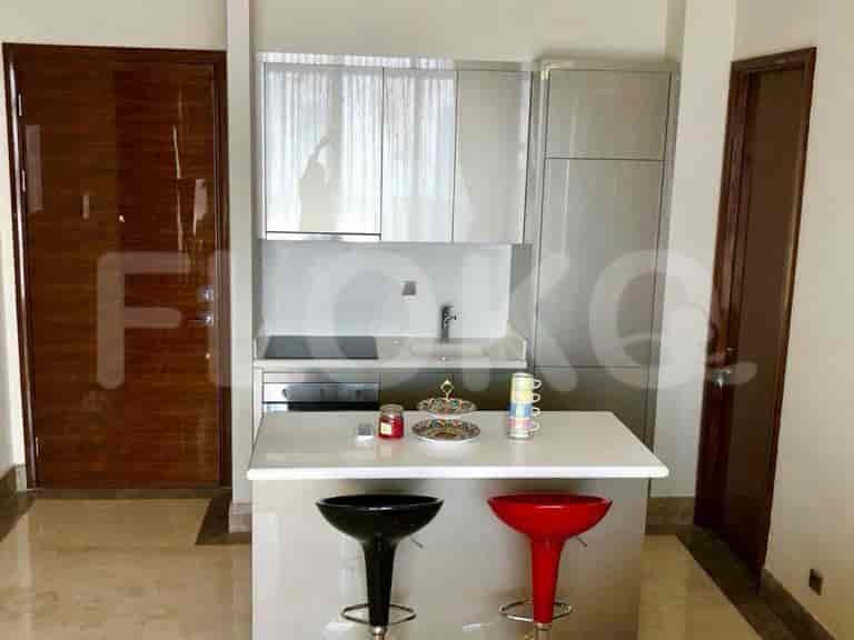 A modern kitchen with a breakfast bar and sleek cabinetry.