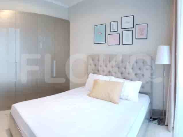 Kamar tidur dengan tempat tidur besar dan karya seni.