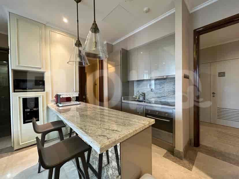 Kitchen featuring an island with stools, and appliances.