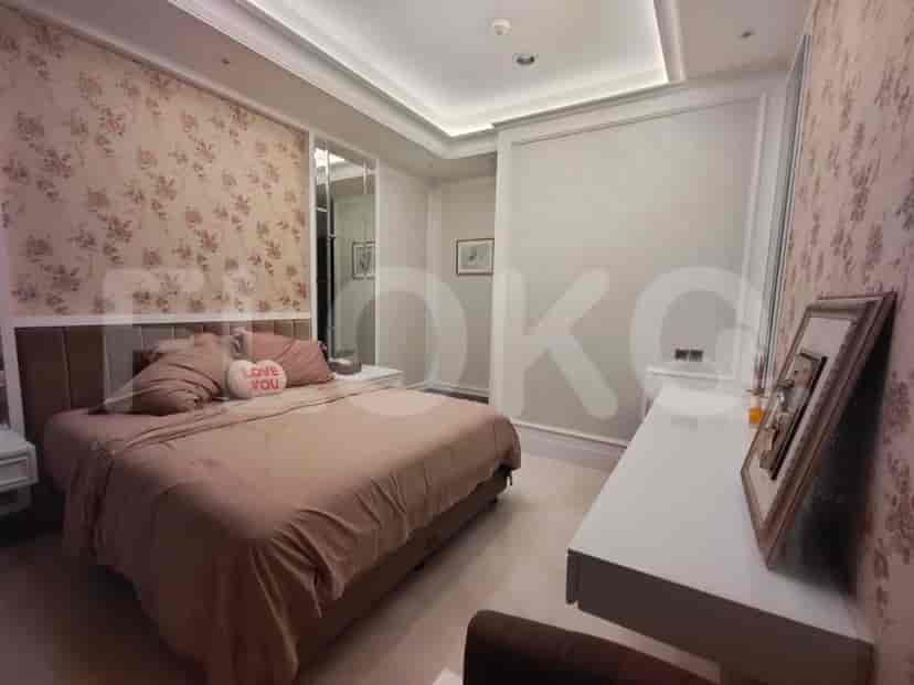 Bedroom with a bed, dressing table, and floral wallpaper.