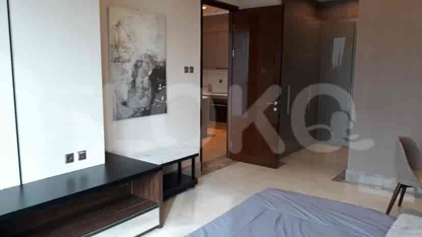 Another view of a modern bedroom with a large bed, windows, and an entryway.