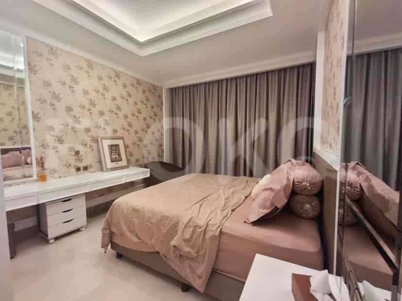Bedroom with a king-sized bed, floral wallpaper, and a vanity.