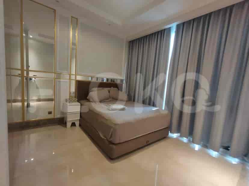 Modern bedroom with a king-sized bed and a mirrored wall.