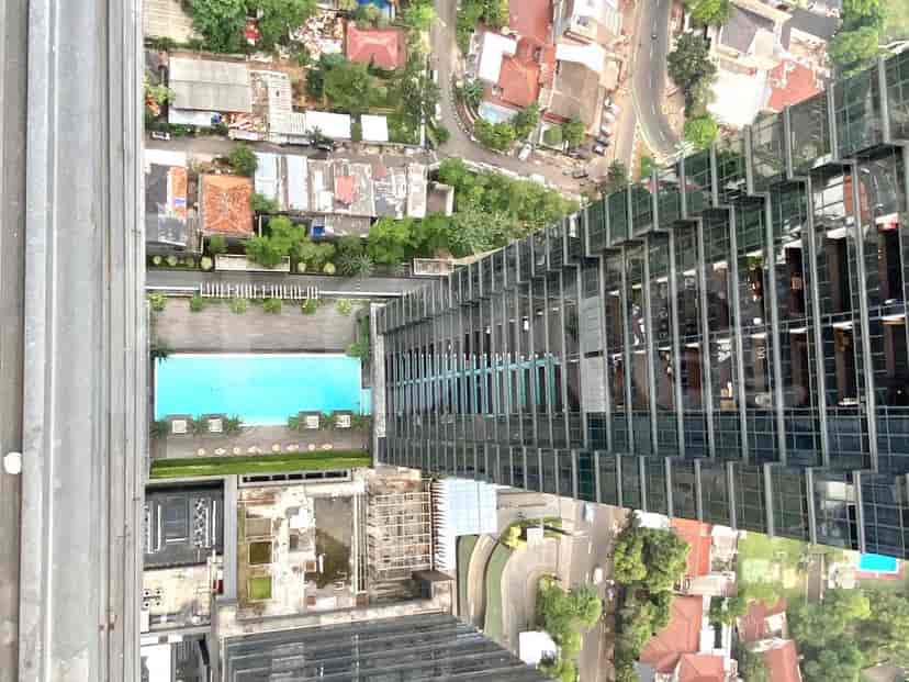 View from high above showing a pool and the city.