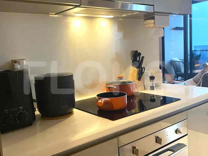 Modern kitchen with a countertop, stove, and built-in appliances.