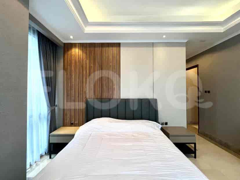 The bedroom showcases a king bed and a modern design with wood paneling.