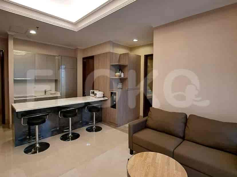 Modern kitchen with a breakfast bar, featuring grey cabinetry, stainless steel appliances, and bar stools.