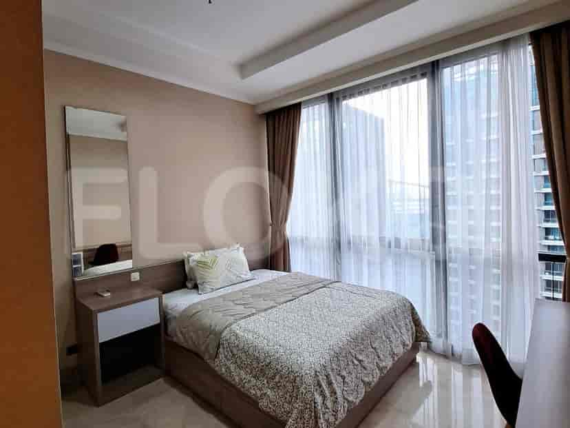 Bedroom with a bed, window, and curtains.