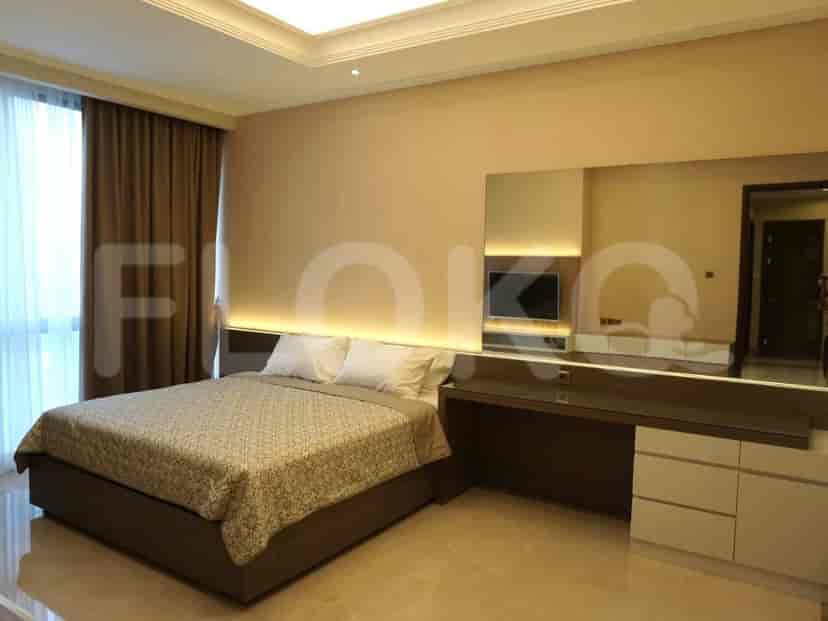 Bedroom with a bed, desk, and large mirror.
