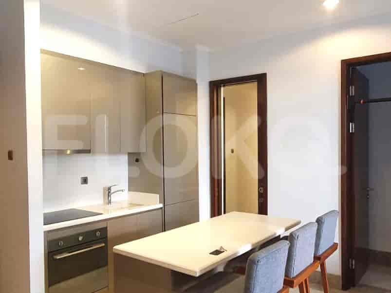 Modern kitchen with cabinets, counter seating, and integrated appliances.