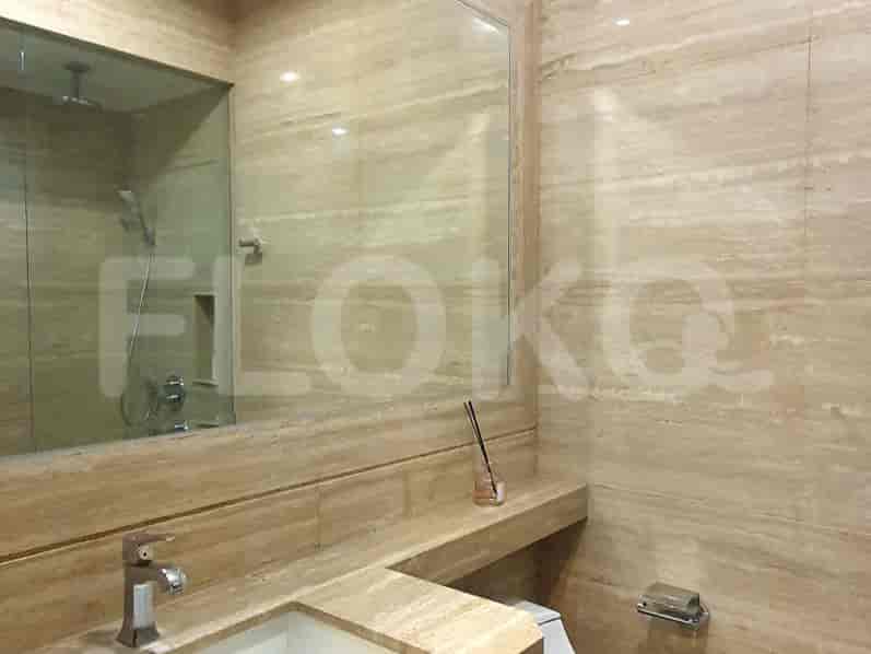 Luxurious bathroom with marble finishes, a large mirror, and a sink.