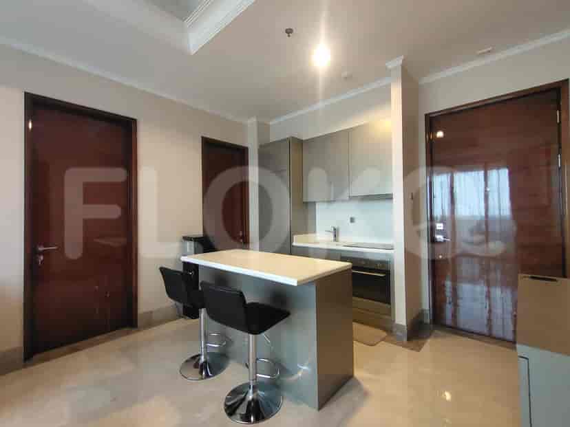 A modern kitchen featuring a breakfast bar with seating and stainless steel appliances.