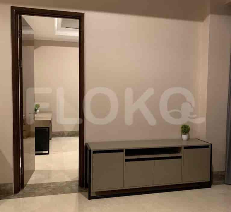 A hallway with a cabinet, and access to other rooms.