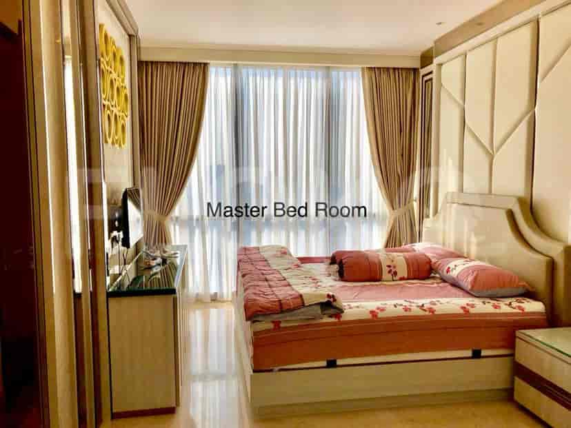Master bedroom with a large bed, curtains, and wall-mounted TV.